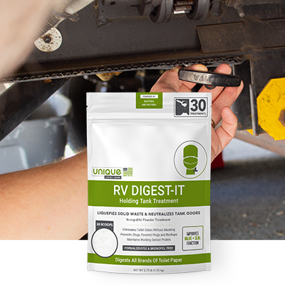 RVer opening an RV waste valve with RV Digest-It front and center.