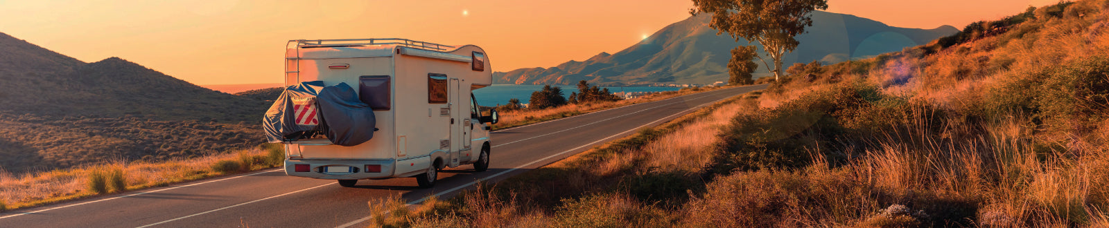 RV driving off into the sunset. Unique Camping + Marine