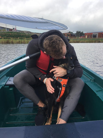 Árón Taylor-Smith unwinding with his dog, Archie, on a boat.