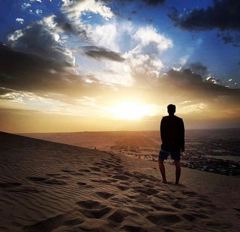 Darragh Lucey Hiking Sand Dunes in Huachina, Peru wearing Gym+Coffee gear