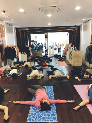 Attendees relax on yoga mats as Lydia Sasse leads a Yoga for Stress Reduction class at Gym+Coffee Liffey Valley
