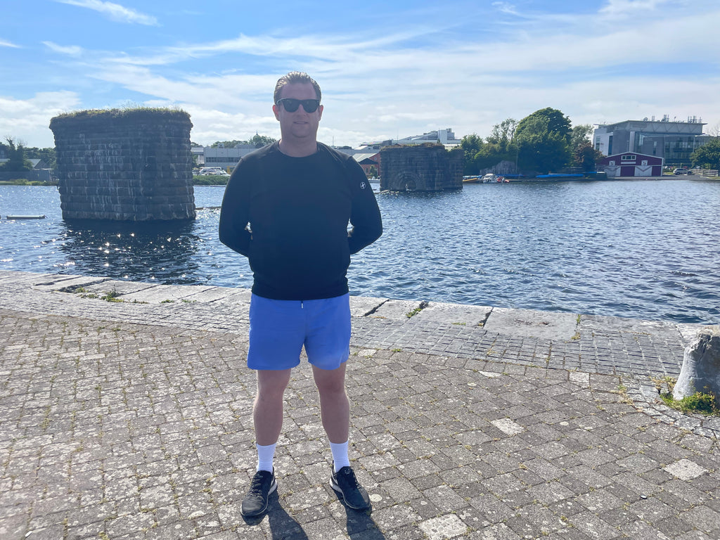 Phelim wearing the District Crew in Black and the Pace Shorts in Amparo Blue.