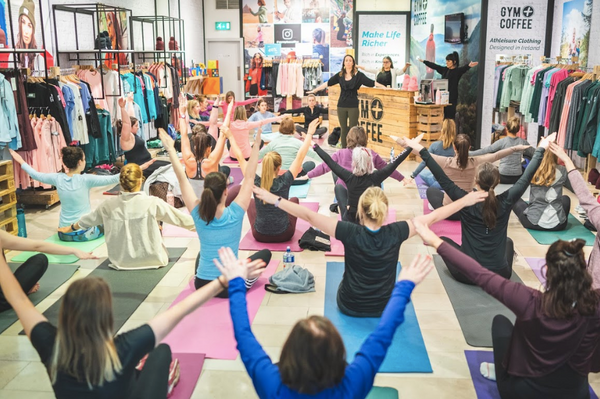 Group Yoga class with Lydia Sasse at Gym+Coffee Dundrum with attendees stretching