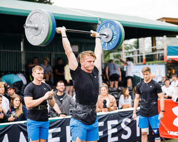 Fred Ray completing a ground to overhead barbell lift at the London Turf Games