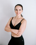 Daniela Spear - standing arms folded and smiling toward the camera