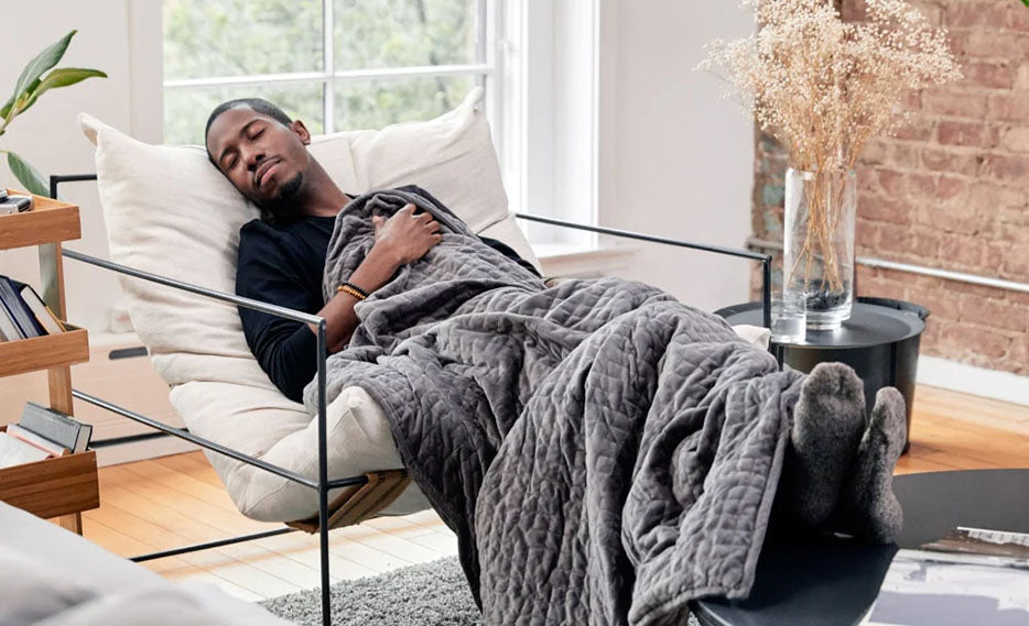 man sleeping with weighted blanket