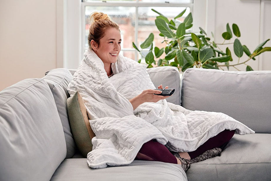 woman using white weighted blanket