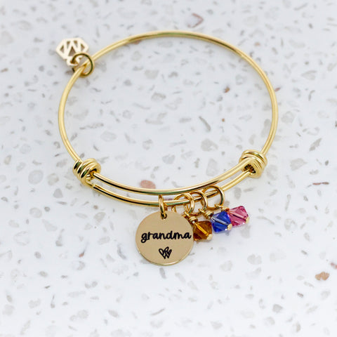 Personalized Grandma Birthstone Bangle in Gold on Terrazzo Background