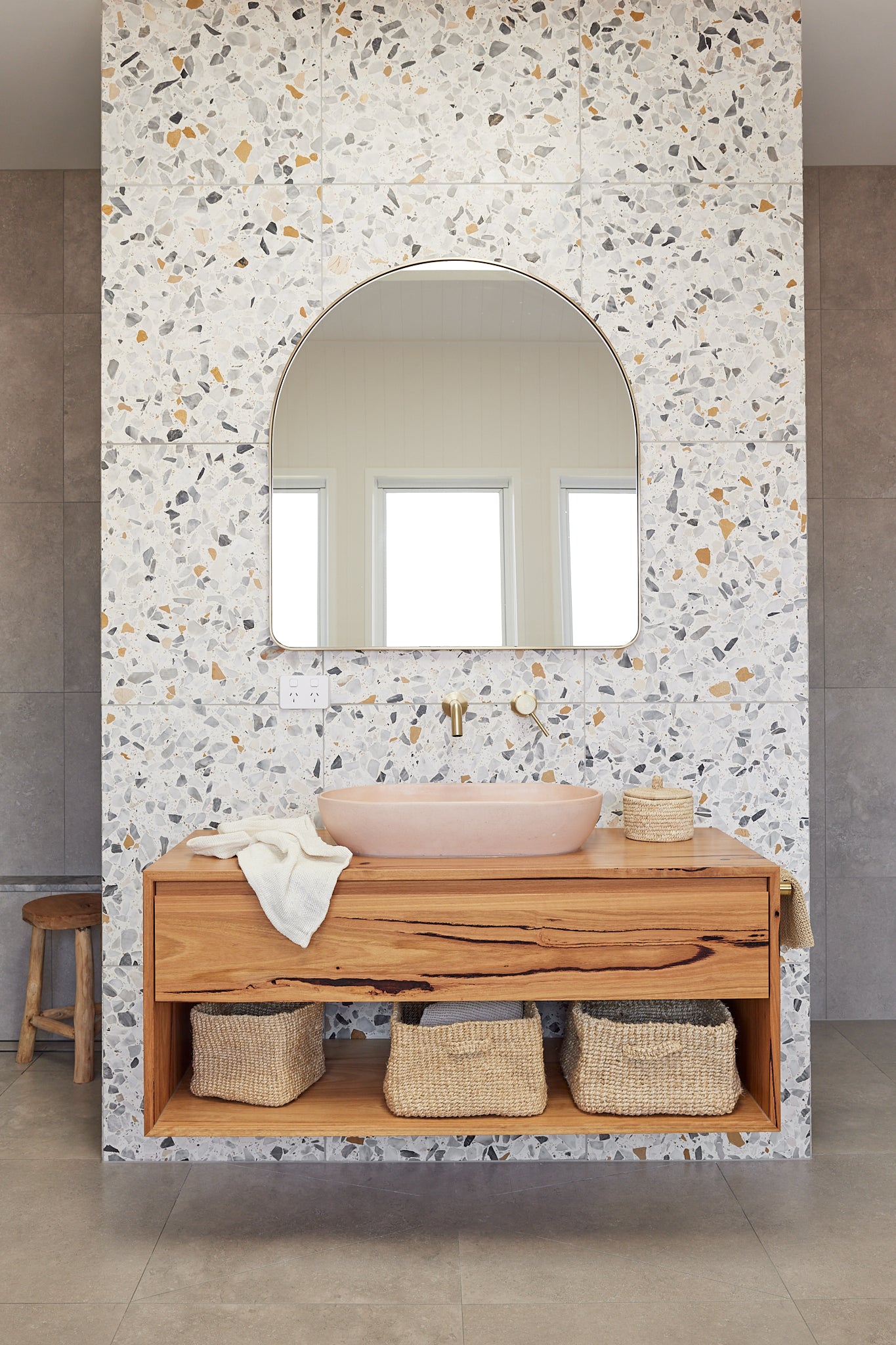 bathroom with woven jute baskets, terrazzo tiles, timber vanity, pink concrete basin at Sundream Burleigh Heads