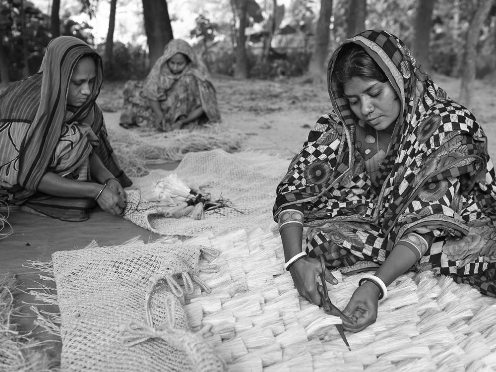 Fair trade - three fair trade artisans hand-making decorative tassles.