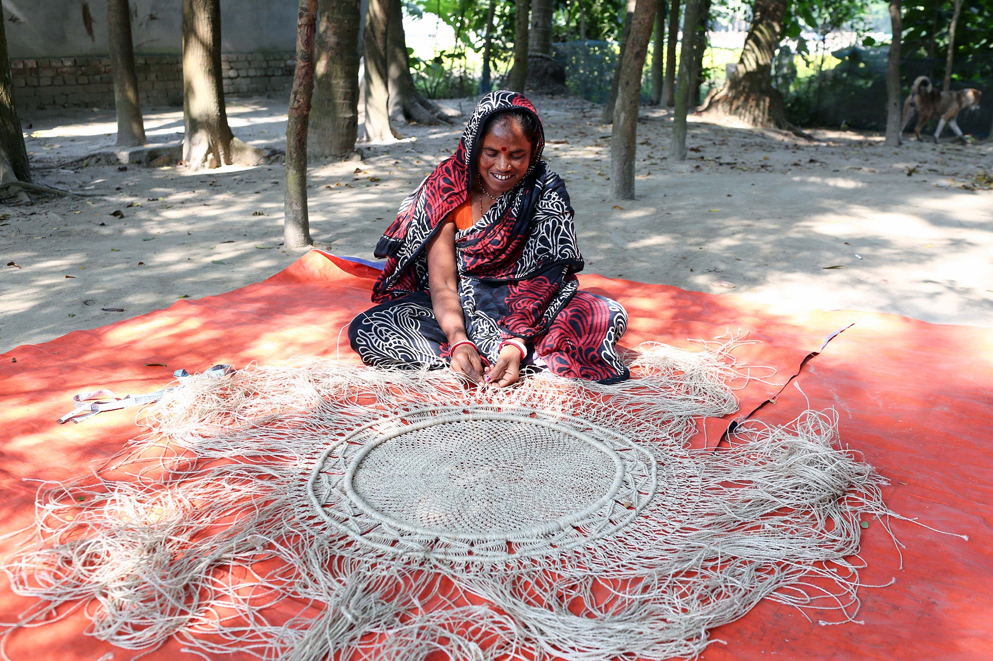 The Dharma Door Fair Trade artisan making a mandala wall hanging