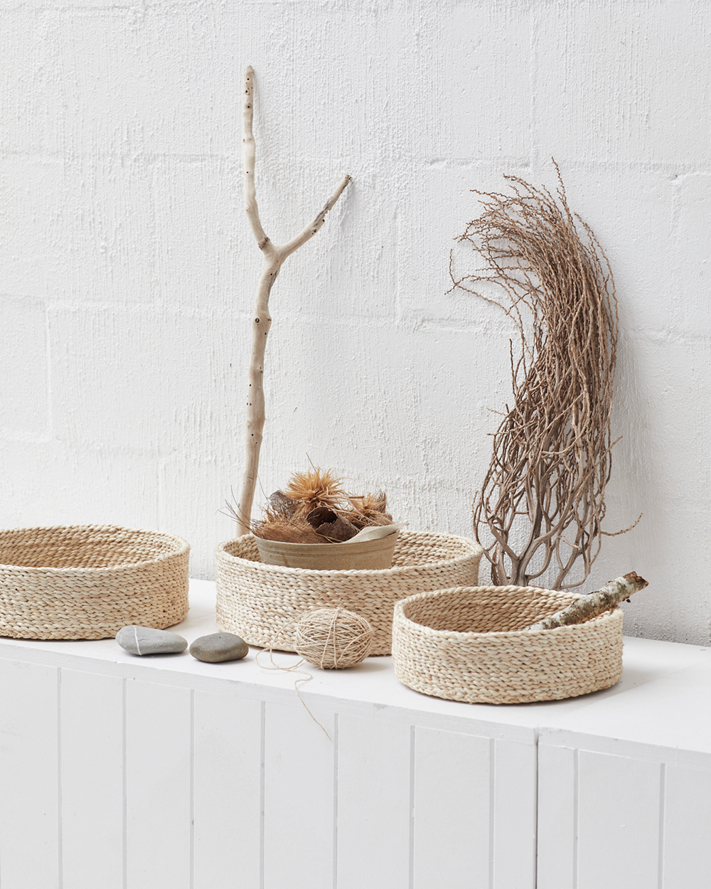 woven jute baskets holding foraged objects from nature