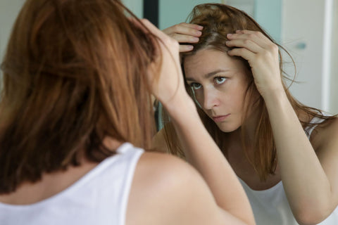woman_examining_scalp_itchy_scalp_dandruff_flaking_scalp_hair_loss