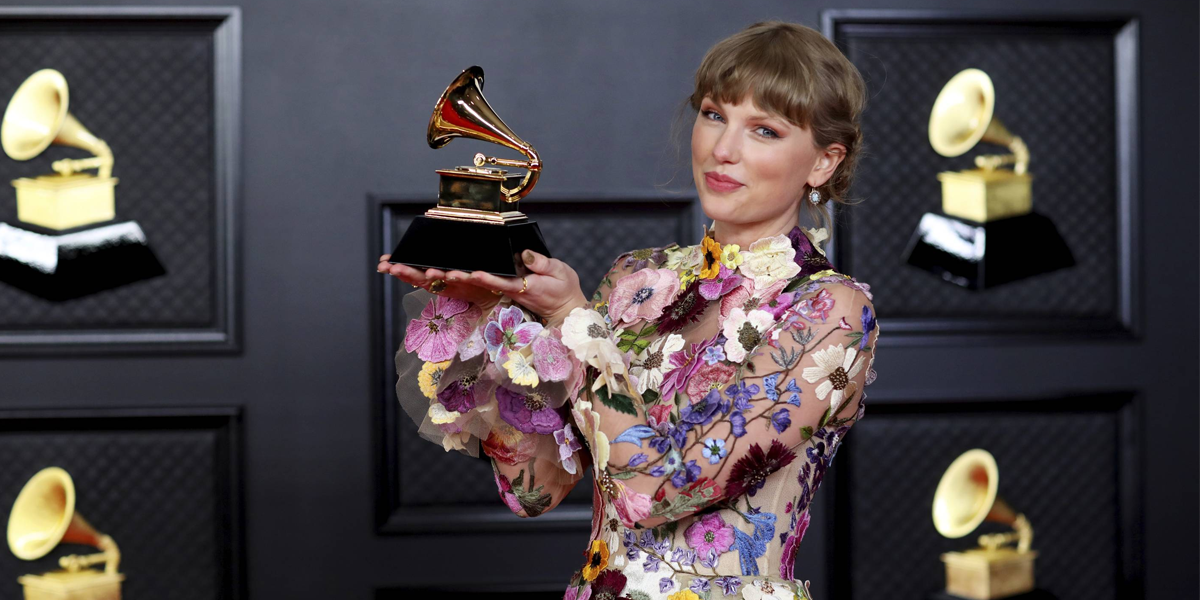 Taylor Swift posing on the GRAMMYs red carpet in 2021