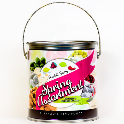 Decorative can with pastel spring colors; Chef in front of bright pink ribboned banner that says "Spring Assortment"; Chef is gesturing to carton images of a lemon, raspberry, key lime, and chipotle pepper