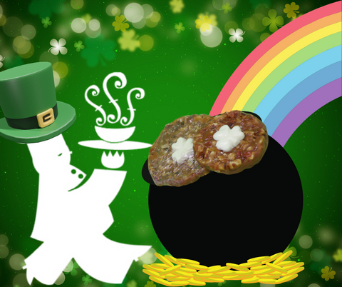 Green background with gold shamrocks scattered across the top; A white chef wearing a leprechaun hat on the left, a pot of gold at the end of a rainbow on the right; Two chocolate turtles with Shamrock white chocolates on top sit inside the pot of gold