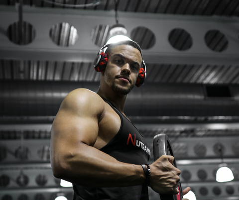 Man lifting weights in front of mirror