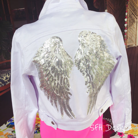 white denim jacket with silver wings embroidered on the back