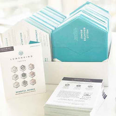 A box of LumenKind envelopes sitting next to Neuroscientist Dr. Tara Swart's collaboration Pack.