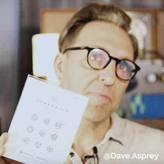 Bulletproof founder and biohacker Dave Asprey holds a Pack of Mindful Marks and shows temporary tattoos with intentions.