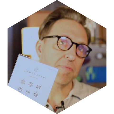 Bulletproof founder and biohacker Dave Asprey holds a Pack of Mindful Marks and shows temporary tattoos with intentions.