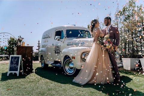 Bride and groom in front of a white Tap Truck