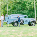 New England mobile bar truck with beautiful bride and groom at wedding in the countryside.