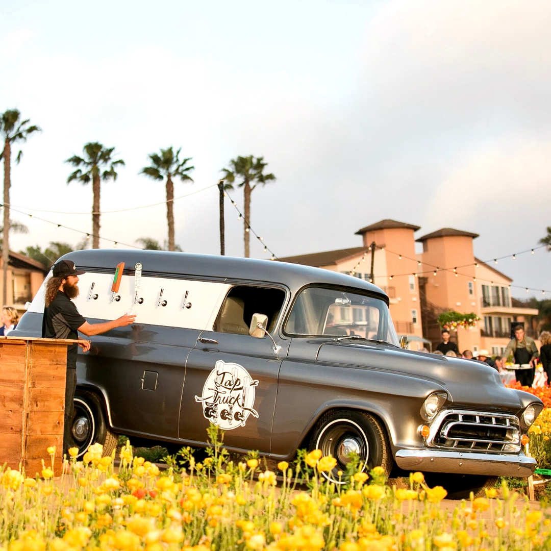 Classy event venue with vintage mobile bar truck and bride and groom