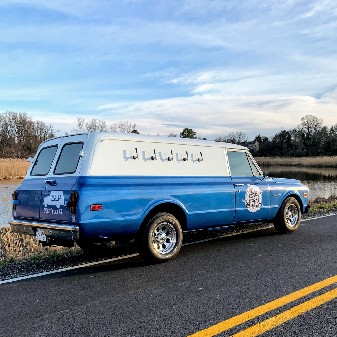 Classy event venue with vintage mobile bar truck and bride and groom