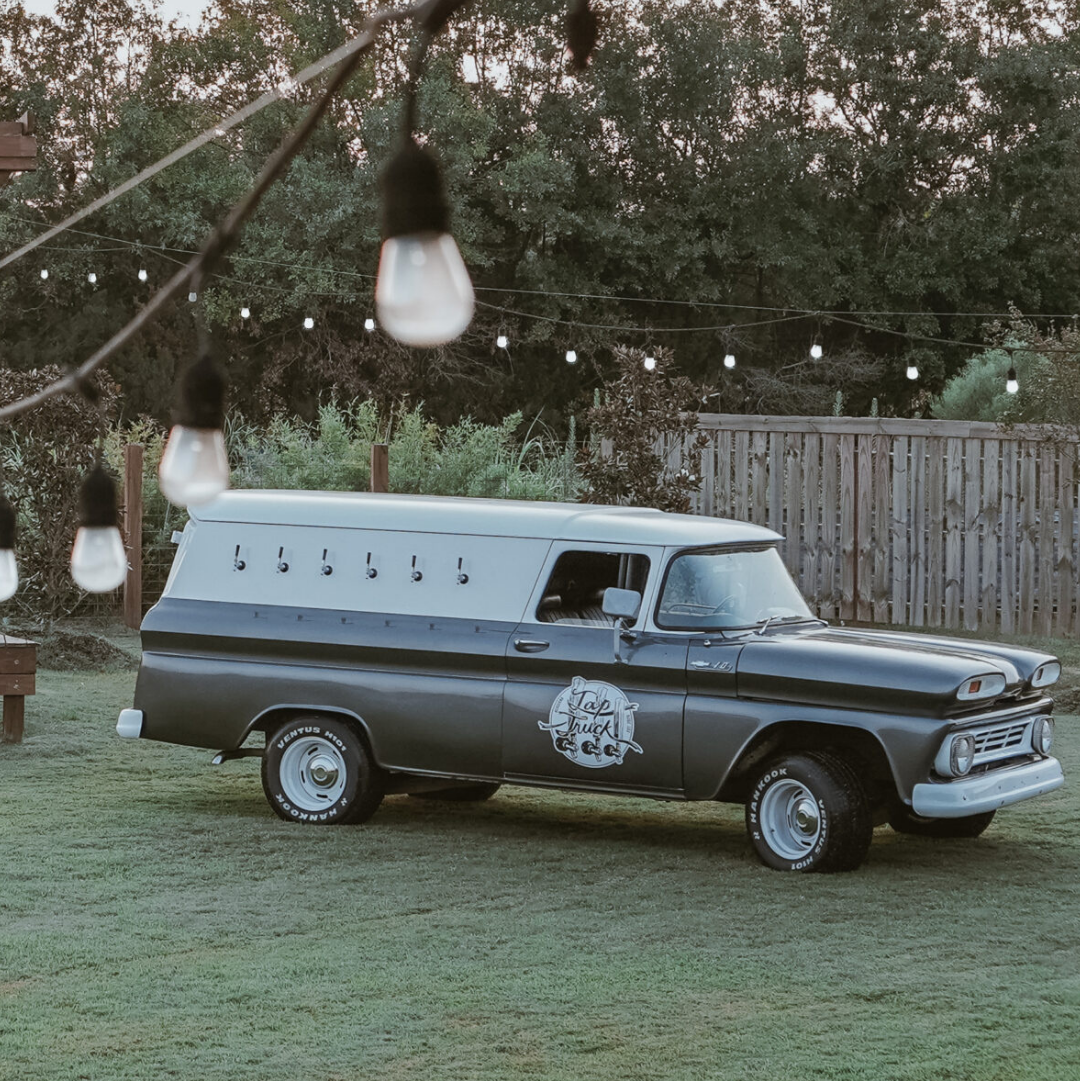 Classy event venue with vintage mobile bar truck and bride and groom