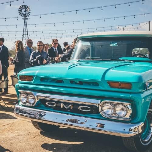Blue GMC classic bar truck with event guests in the California desert 