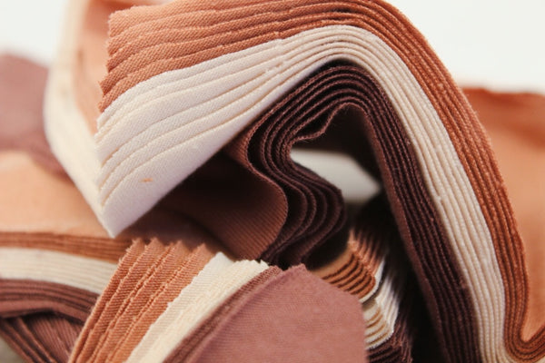 stack of fabrics in nude shades