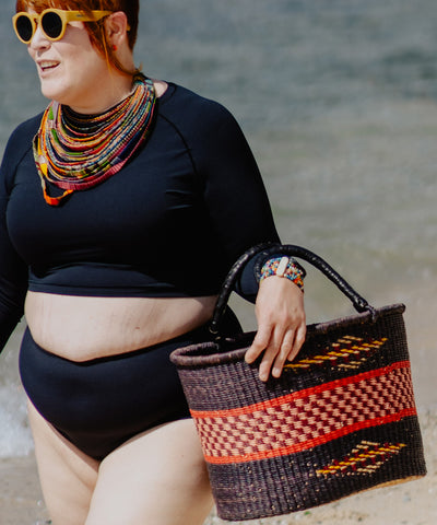 pam carrying a woven beach basket by simpatico