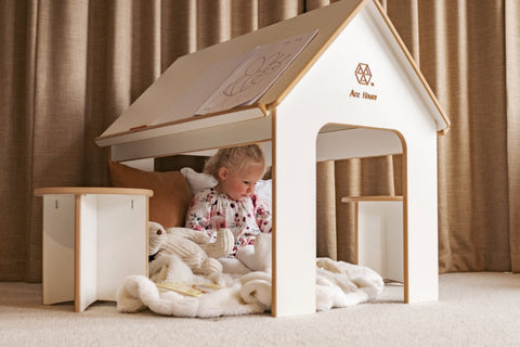 Girl playing with her teddies under the Arc House kids indoor playhouse