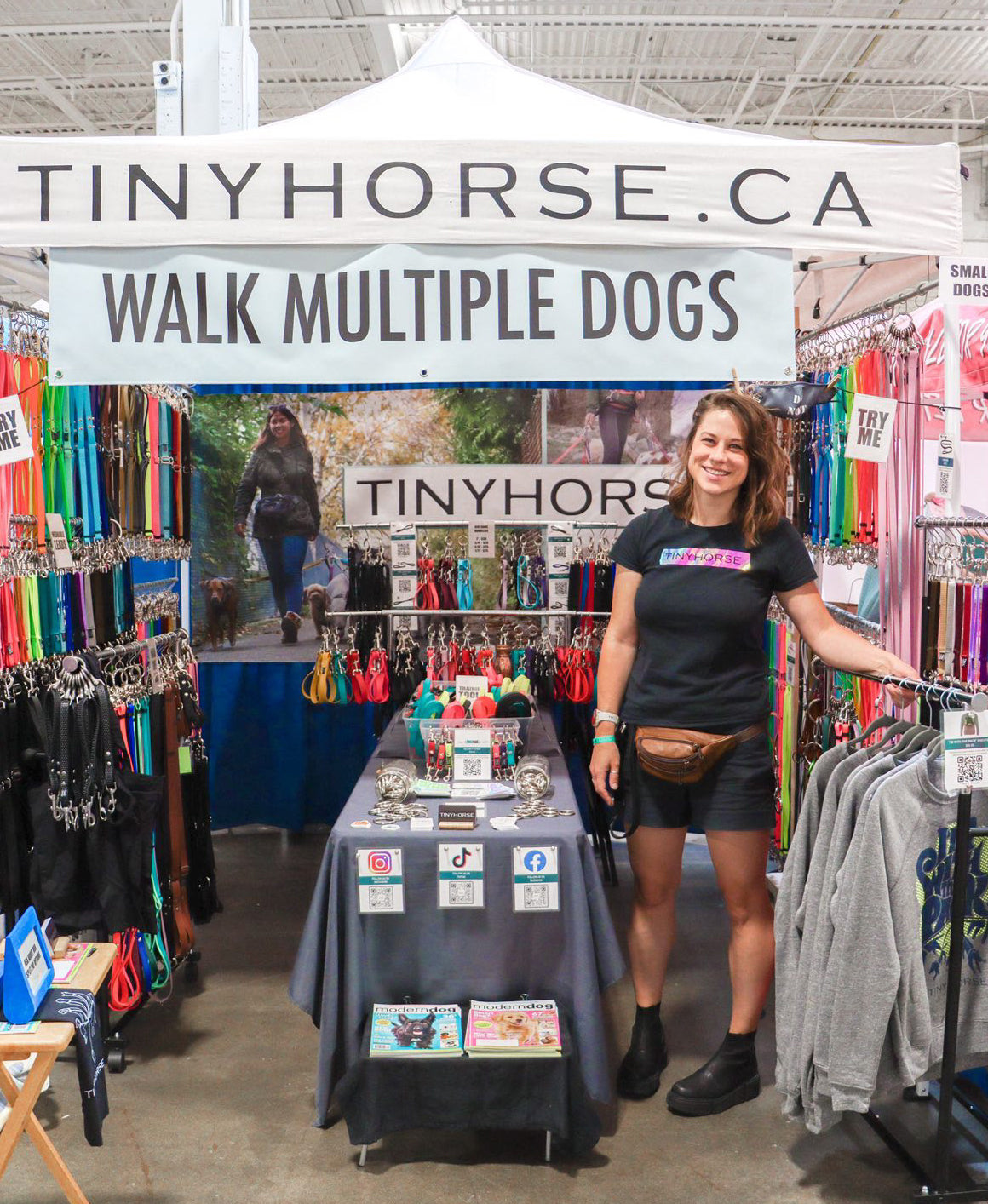Taylor standing in front of the TinyHorse booth at the Canadian Pet Expo