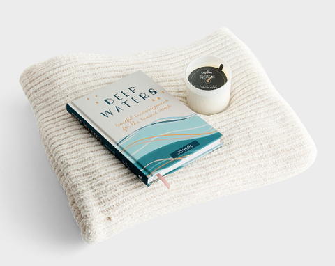 a blanket, a book and a candle