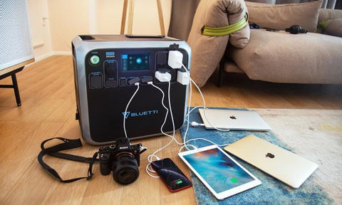Photo of Bluetti - AC200 1700Wh/2000W Portable Power Station hooked in a 3 tablets, 1 cellphone and a camera.