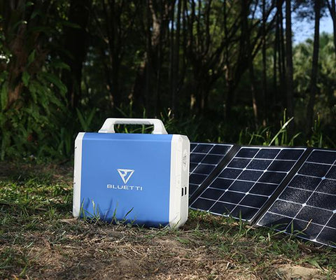 Photo of Bluetti - EB240 2400Wh/1000W Portable Power Station in front of the solar panels.