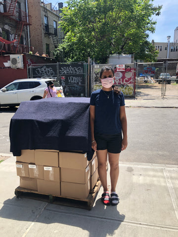 Person next to a pallet of boxes