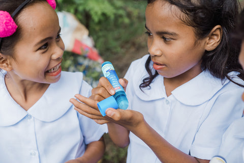 Indigenous kids enjoying soap pens at a handwashing awareness campaign