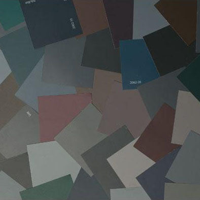 image of multiple bold and dramatic paint color chips laid out on top of one another