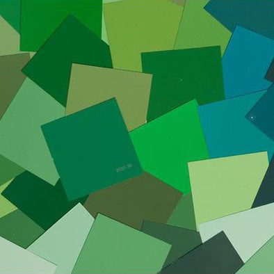 image of multiple green paint color chips laid out on top one another