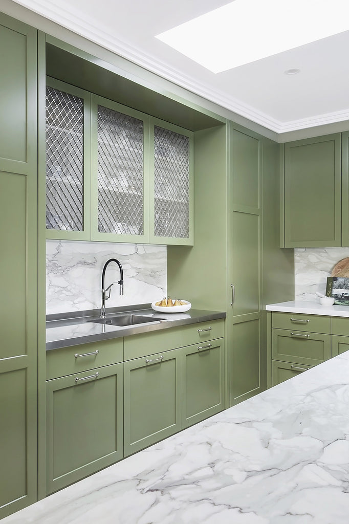 Green Kitchen with Marble Worktop and Silver Decorative Grille