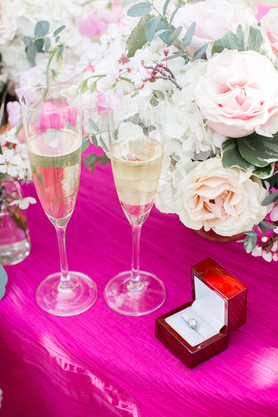 ring and champagne on table