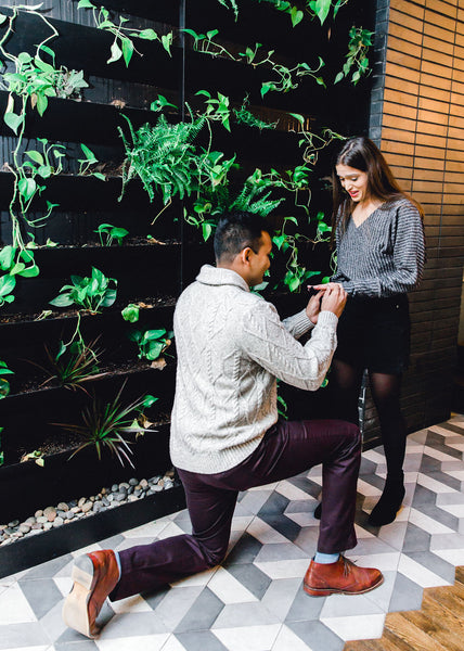 wedding proposal in front of greenery