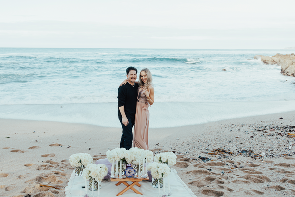 couple getting engaged at the beach