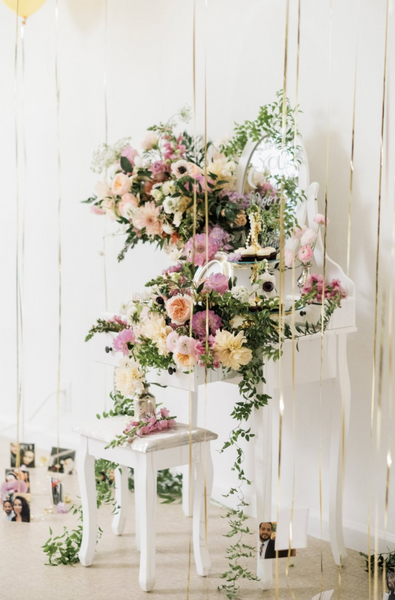 pink and purple flowers on table with balloons