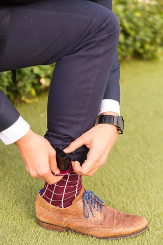 man pulling engagement ring out of pocket sock for winery proposal