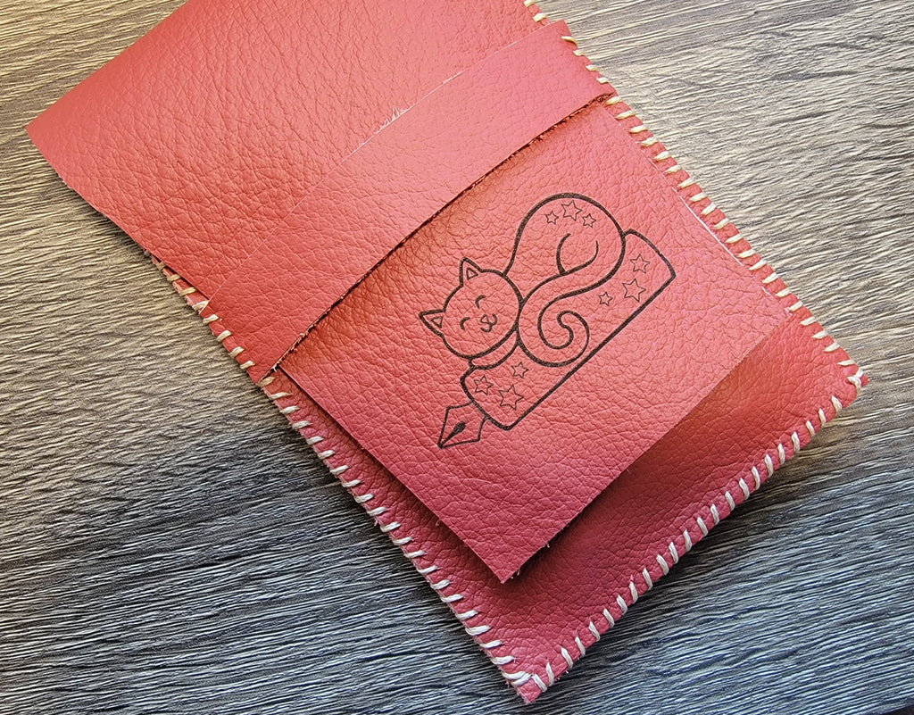 leather pen pouch with a cat design
