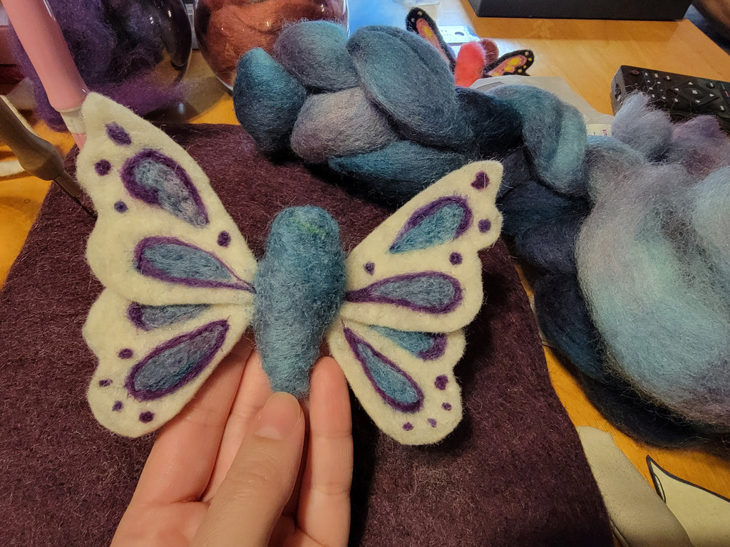 needle felted butterfly with white, purple, and blue
